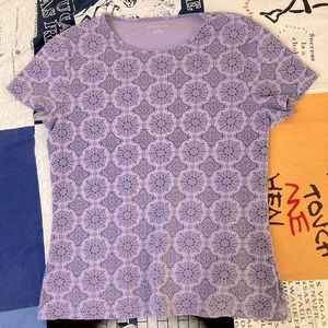 Intricately patterned purple t-shirt.